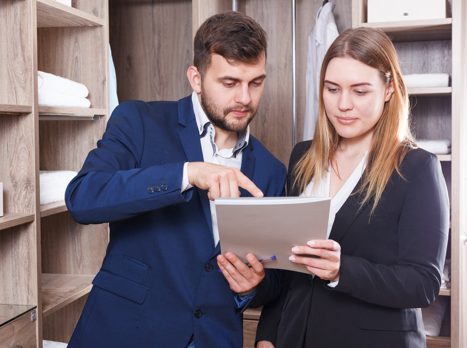 Administrator and seller discussing documents